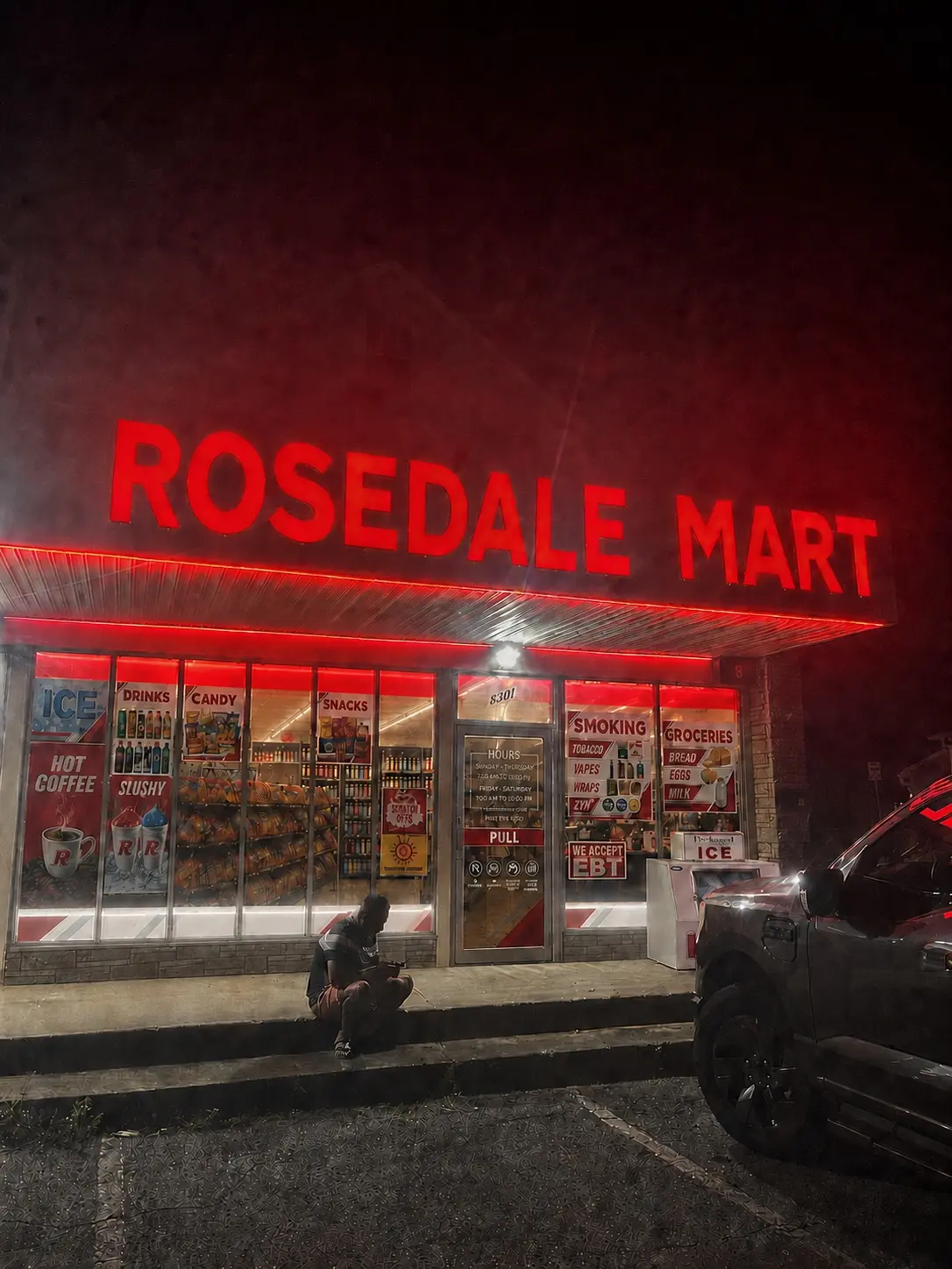 Rosedale Mart storefront illuminated in signature red lighting on Philadelphia Road in Rosedale Maryland